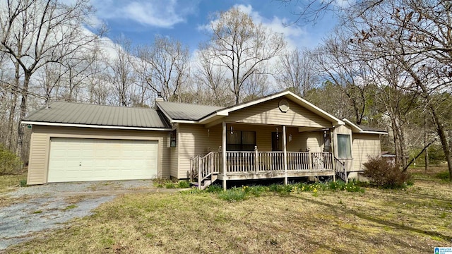 ranch-style home featuring a porch, a garage, and a front yard