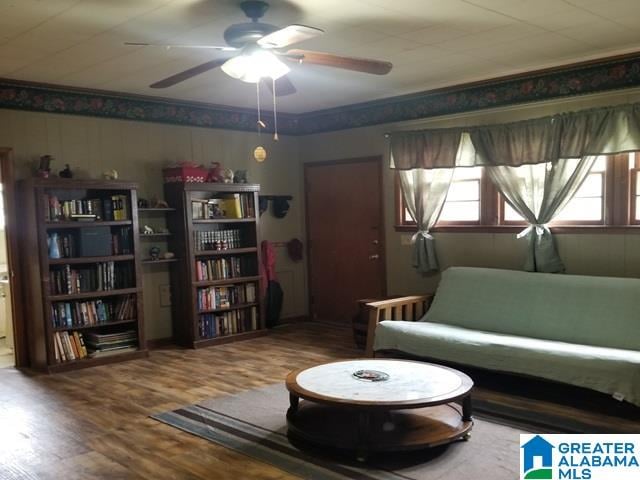 living area with hardwood / wood-style floors and ceiling fan