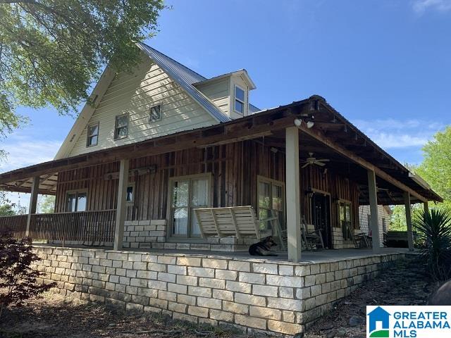 view of side of property with a porch