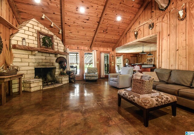 living room featuring high vaulted ceiling, wooden ceiling, a stone fireplace, and beamed ceiling