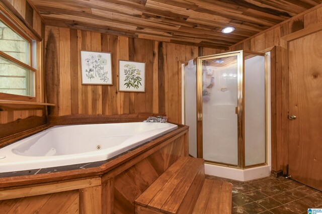 bathroom with tile floors, wooden ceiling, wood walls, and plus walk in shower