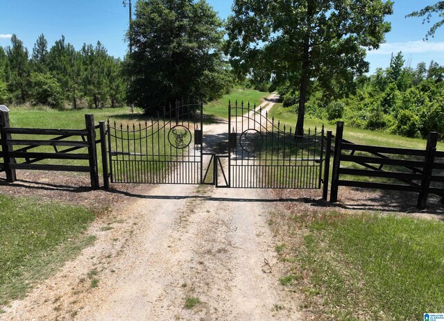 view of gate featuring a yard