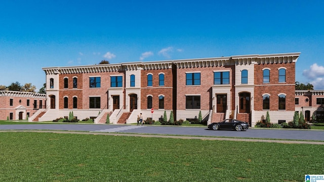 view of front of house featuring brick siding and a front lawn