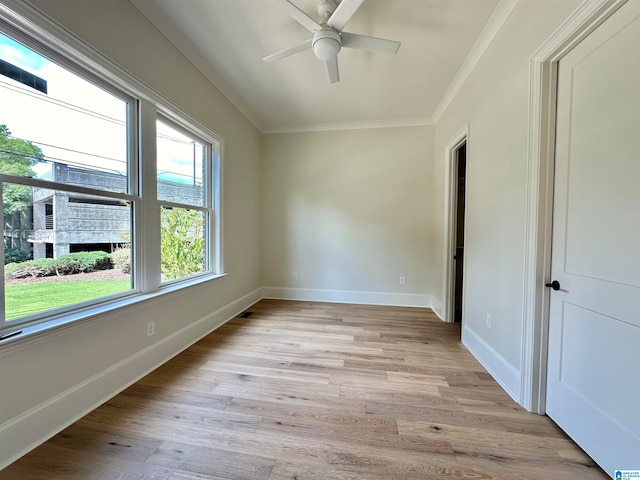 empty room with ornamental molding, ceiling fan, and light hardwood / wood-style flooring