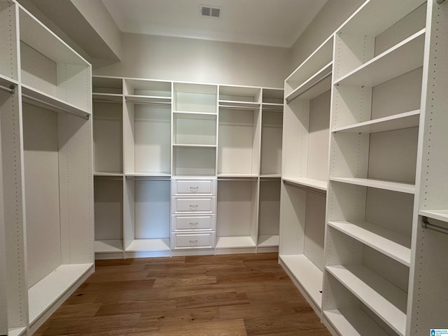 spacious closet with hardwood / wood-style floors