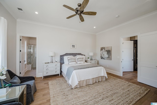bedroom featuring visible vents, ornamental molding, baseboards, and wood finished floors