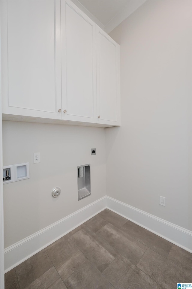 clothes washing area with hookup for an electric dryer, gas dryer hookup, baseboards, cabinet space, and washer hookup
