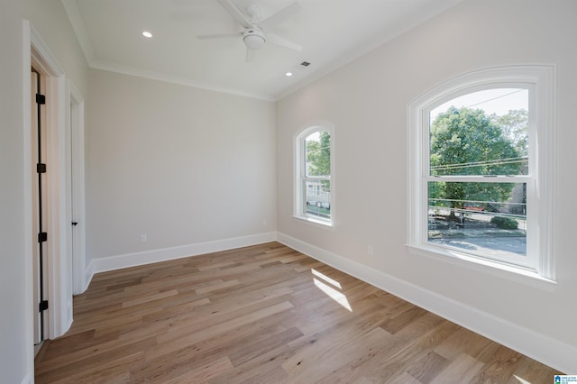 spare room with ornamental molding, baseboards, light wood finished floors, and recessed lighting