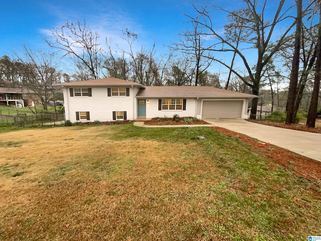 split level home with a front yard and a garage