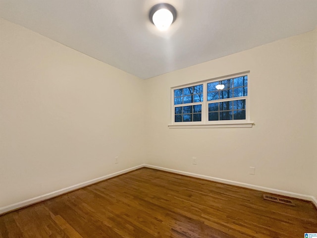 empty room with dark hardwood / wood-style floors