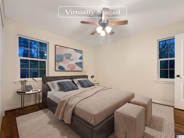 bedroom with ceiling fan and dark wood-type flooring