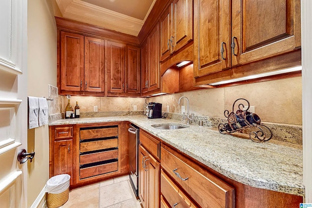 kitchen with backsplash, crown molding, light tile flooring, light stone counters, and sink