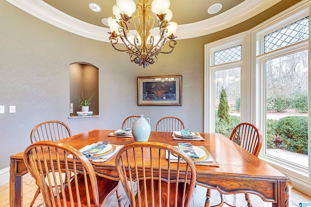 dining area with an inviting chandelier and ornamental molding