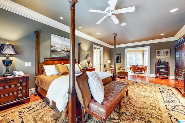 bedroom featuring hardwood / wood-style floors, ceiling fan, and crown molding