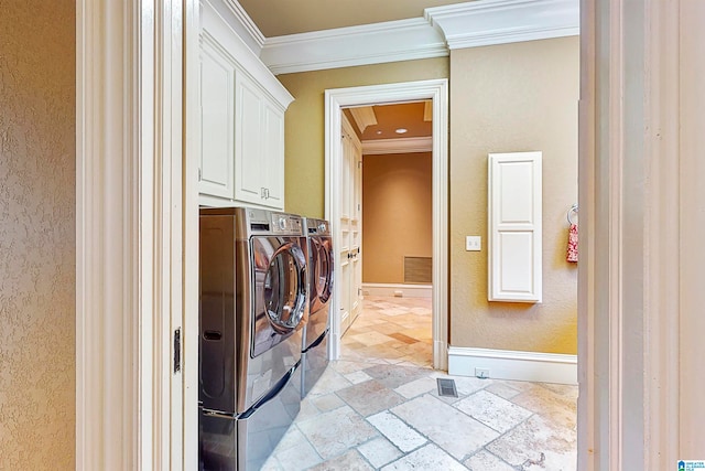 clothes washing area with cabinets, ornamental molding, separate washer and dryer, and light tile flooring