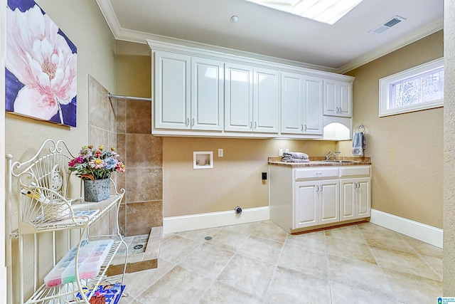 laundry area with light tile floors, cabinets, sink, hookup for a washing machine, and crown molding