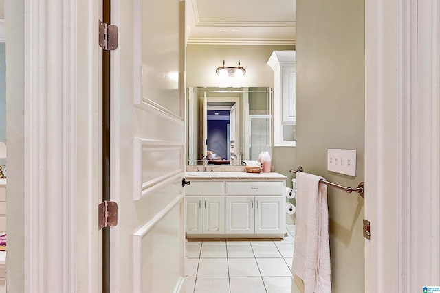 bathroom featuring vanity with extensive cabinet space, crown molding, and tile flooring