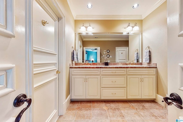 bathroom featuring ornamental molding, double vanity, and tile floors