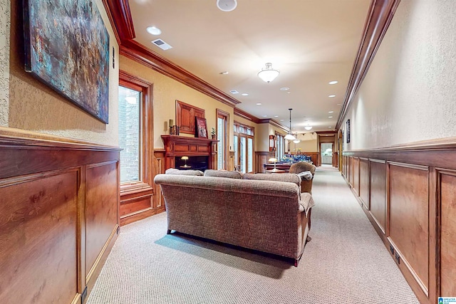 carpeted living room with ornamental molding