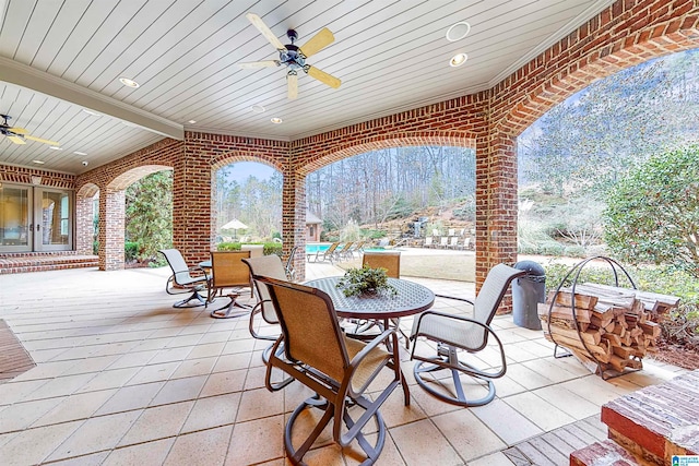 wooden terrace with a mountain view and ceiling fan