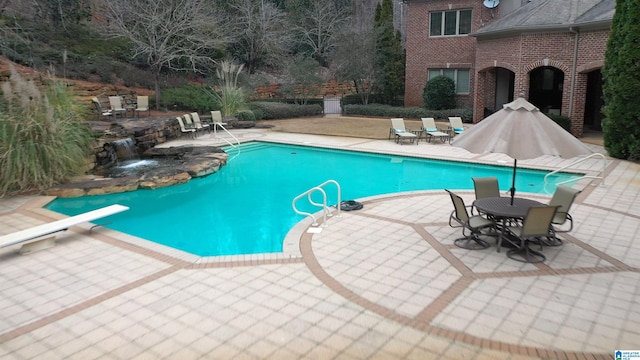 view of swimming pool with a patio area