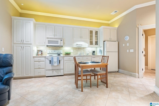 kitchen featuring ornamental molding, white appliances, light tile floors, and white cabinets