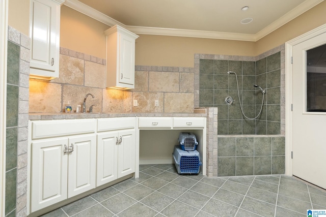 bathroom with crown molding, tasteful backsplash, vanity, tiled shower, and tile floors