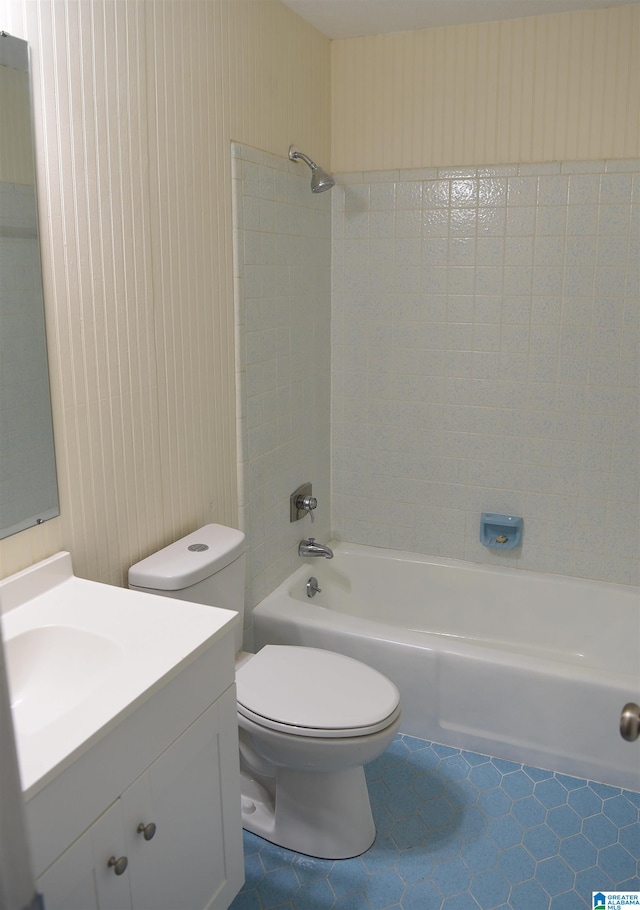 full bathroom with toilet, vanity, tiled shower / bath, and tile flooring