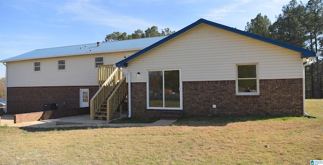 back of house featuring a yard, a patio area, and central AC unit