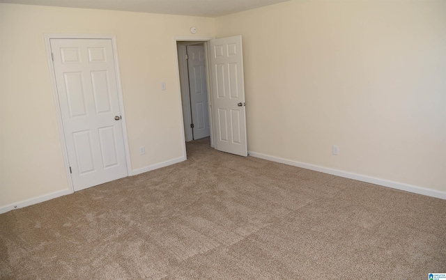 unfurnished bedroom with light colored carpet