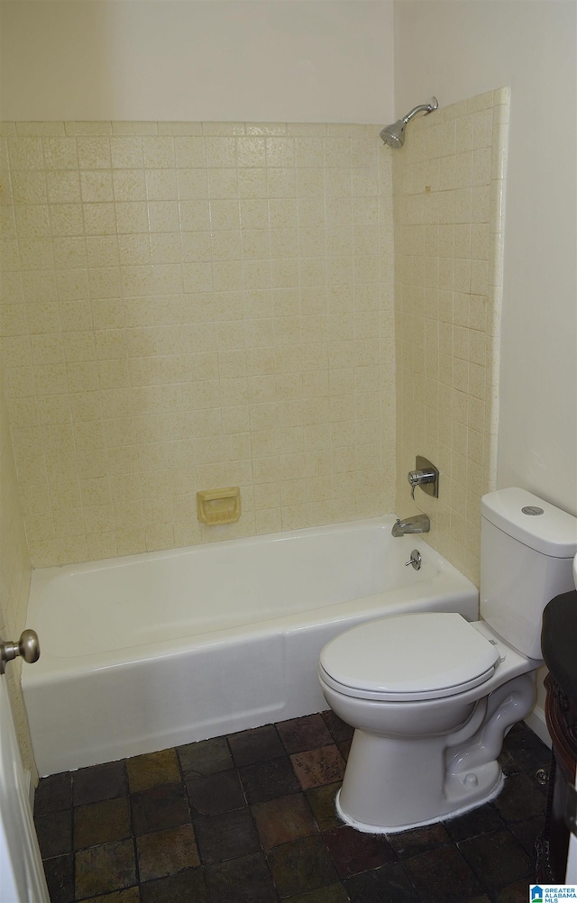 bathroom featuring toilet, tile flooring, and tiled shower / bath combo