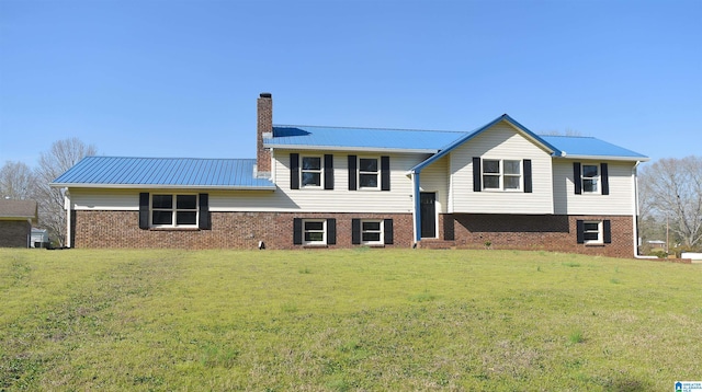 rear view of property featuring a yard