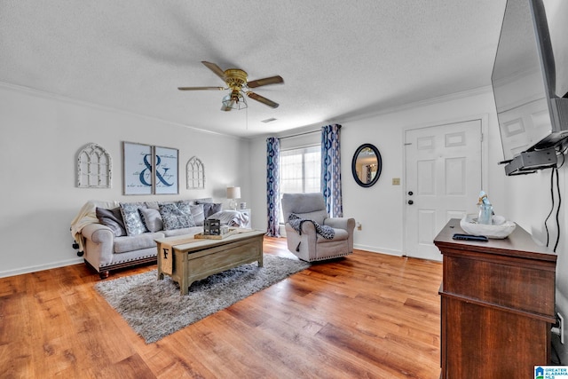 living room featuring a textured ceiling, crown molding, ceiling fan, and light hardwood / wood-style flooring