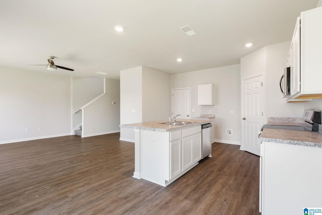 kitchen with a kitchen island with sink, stainless steel appliances, dark hardwood / wood-style flooring, white cabinets, and sink