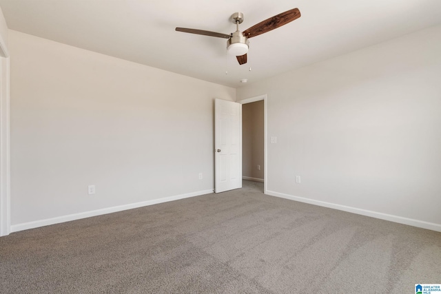 spare room featuring ceiling fan and carpet