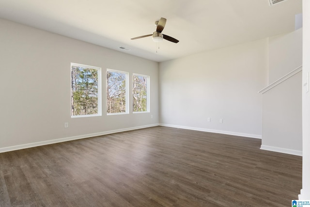 empty room featuring ceiling fan and dark hardwood / wood-style flooring