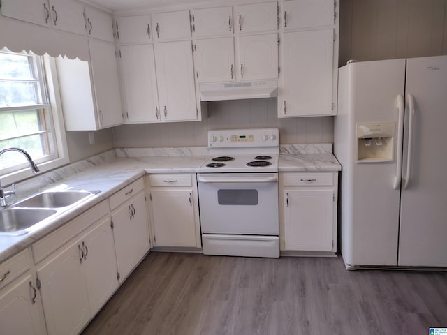 kitchen with backsplash, white appliances, sink, light hardwood / wood-style flooring, and white cabinets