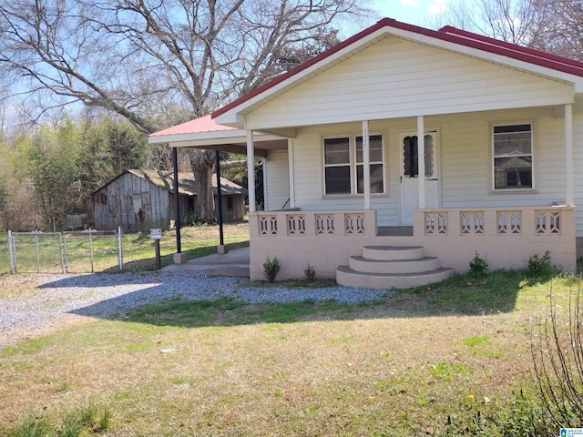 bungalow-style home with covered porch and a front yard