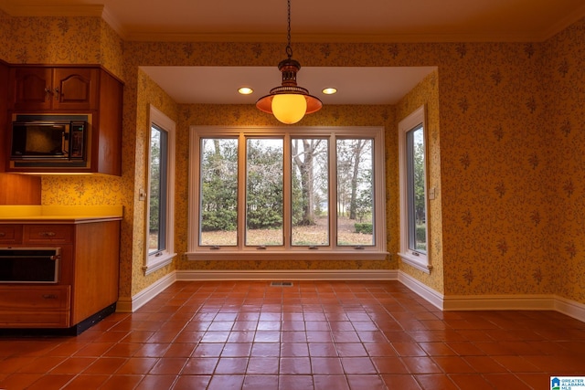 unfurnished dining area featuring dark tile flooring