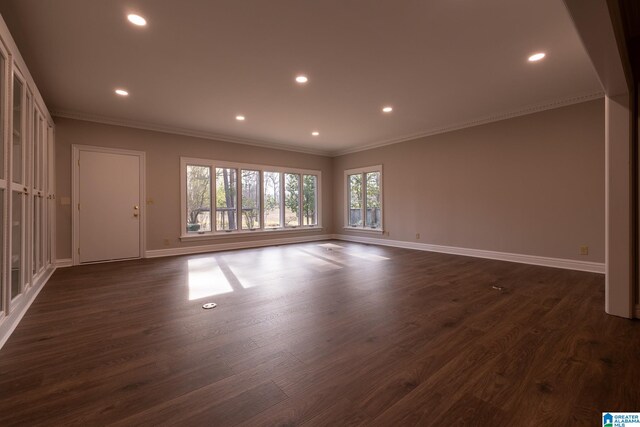 spare room featuring dark hardwood / wood-style flooring and crown molding