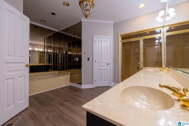 bathroom featuring crown molding, an inviting chandelier, dual bowl vanity, and hardwood / wood-style flooring