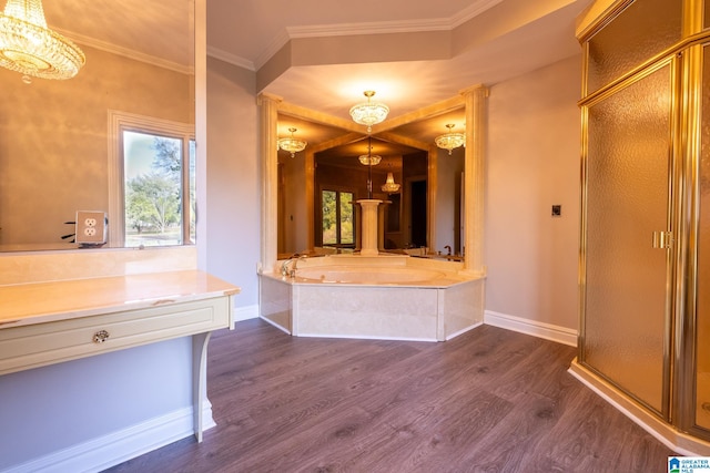 bathroom with an inviting chandelier, ornamental molding, and a healthy amount of sunlight