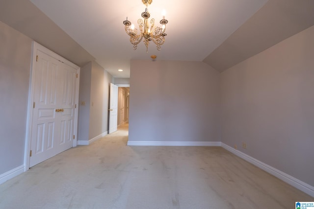 unfurnished bedroom featuring a chandelier and light colored carpet