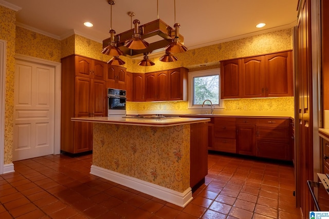 kitchen with gas cooktop, sink, oven, tile floors, and a center island