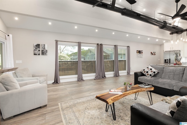 living room featuring ceiling fan and light wood-type flooring