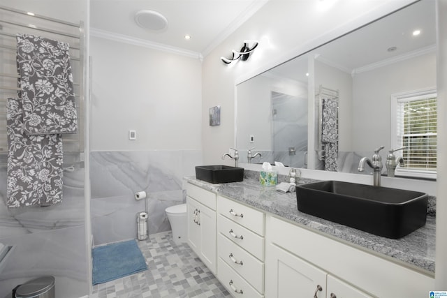 bathroom featuring toilet, double vanity, ornamental molding, tile walls, and tile floors