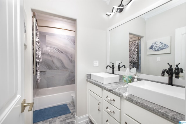 full bathroom with dual sinks, shower / tub combo, toilet, vanity with extensive cabinet space, and tile floors