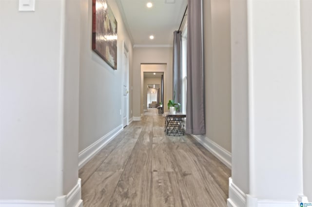 hall featuring light hardwood / wood-style floors and ornamental molding