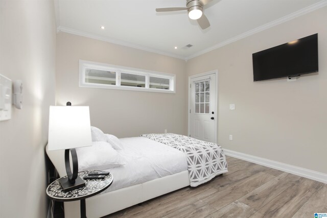 bedroom featuring ornamental molding, ceiling fan, and light hardwood / wood-style flooring