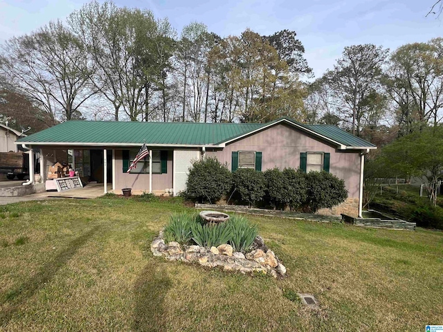 view of front of house featuring a front lawn and a patio area